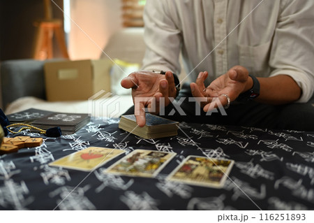 Fortune teller spreading Tarot cards laid out on a table covered with a mystical cloth. Forecasting and divination concept 116251893