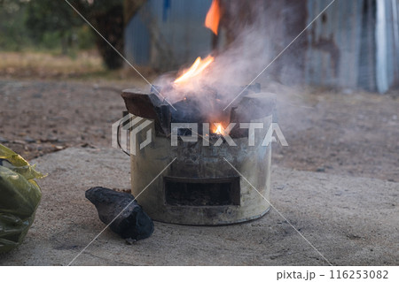 An old-fashioned charcoal stove is lit and ready for traditional rural cooking 116253082