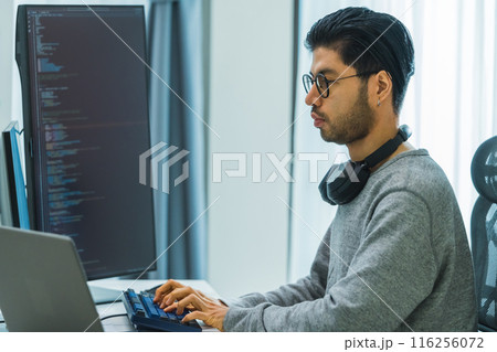 Asian man prompt engineer develop coding app with software data sitting in front of computer monitor at office Asian man prompt engineer develop coding app with software data sitting in front of computer monitor at office 116256072