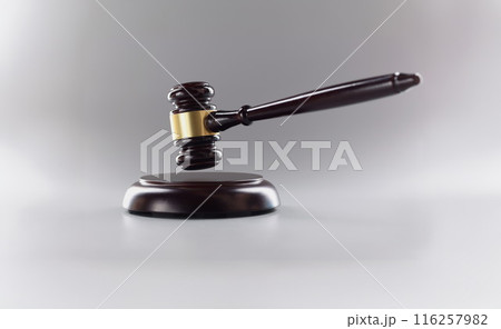 Judges wooden hammer on soundboard placed grey background Judges wooden hammer on soundboard placed grey background 116257982