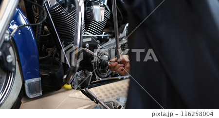 Professional mechanic fixing part of motorbike transport with wrench instrument Professional mechanic fixing part of motorbike transport with wrench instrument 116258004