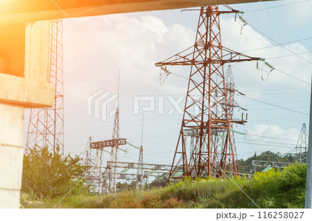 High voltage towers with sky background. Power line support with wires for electricity transmission. High voltage grid tower with wire cable at distribution station. Energy industry, energy saving 116258027