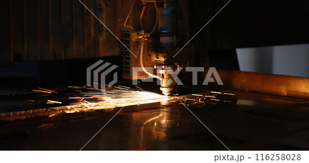 Sparks fly out of automated machine, metal processing laser on metallurgical background 116258028