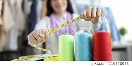 Seamstress stylist keeps centimeter at workplace closeup Seamstress stylist keeps centimeter at workplace closeup 116258088