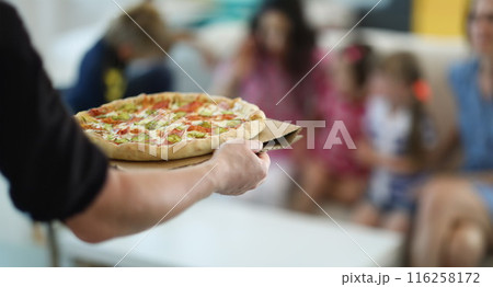 Man bring hot big pizza with stuffing and sauce Man bring hot big pizza with stuffing and sauce 116258172