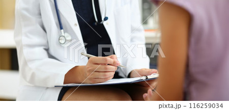 Doctor in medical gown write down patient symptoms, medical appointment Doctor in medical gown write down patient symptoms, medical appointment 116259034