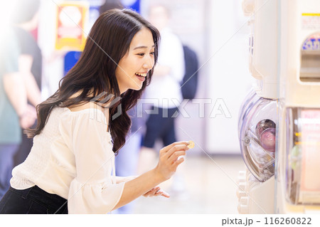 カプセルトイを楽しむ若い女性 116260822