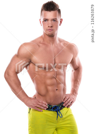 Fitness model in green shorts over white background Fitness model in green shorts over white background 116263879