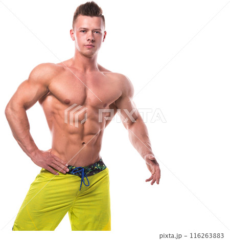 Fitness model in green shorts over white background 116263883