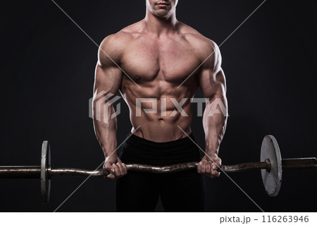 Young man bodybuilder with barbell in studio 116263946