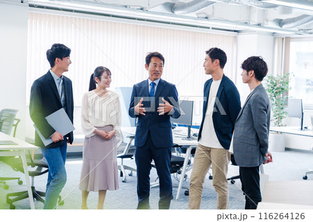 オフィスで立ち話をするビジネスパーソン 116264126