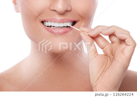 Close up of female teeth and toothpick Close up of female teeth and toothpick 116264224