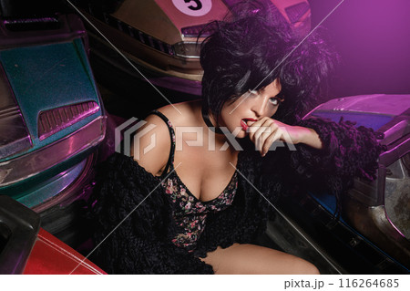 Woman with a cars in the amusement park 116264685