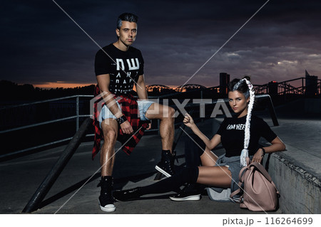 Stylish couple in the skate park at night Stylish couple in the skate park at night 116264699
