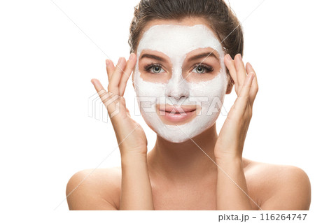 Woman with facial mask on white background 116264747