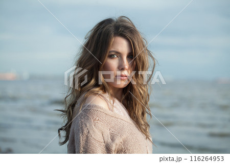 Perfect young adult model woman brunette with long wavy hairstyle and natural make-up 116264953