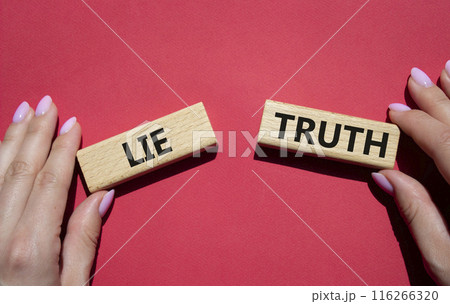 Truth or Lie symbol. Concept word Truth or Lie on wooden blocks. Businessman hand. Beautiful red background. Business and Truth or Lie concept. Copy space Truth or Lie symbol. Concept word Truth or Lie on wooden blocks. Businessman hand. Beautiful red background. Business and Truth or Lie concept. Copy space 116266320