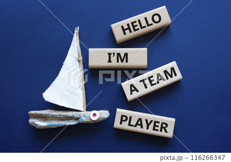 Hello I am a team player symbol. Concept words Hello I am a team player on wooden blocks. Beautiful deep blue background with boat. Business and Hello I am a team player concept. Copy space Hello I am a team player symbol. Concept words Hello I am a team player on wooden blocks. Beautiful deep blue background with boat. Business and Hello I am a team player concept. Copy space 116266347
