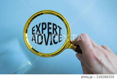 Expert advice symbol. Concept word Expert advice on magnifying glass. Businessman hand. Beautiful blue background. Business and Expert advice concept. Copy space 116266358
