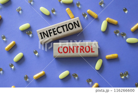 Infection Control symbol. Concept word. Infection Control on wooden blocks. Beautiful purple background with pills. Medicine and Infection Control concept. Copy space 116266600