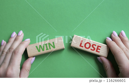 Win or Lose symbol. Concept word Win or Lose on wooden blocks. Businessman hand. Beautiful green background. Business and Win or Lose concept. Copy space 116266601