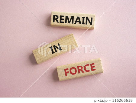Remain in Force symbol. Concept words Remain in Force on wooden blocks. Beautiful pink background. Business and Remain in Force concept. Copy space Remain in Force symbol. Concept words Remain in Force on wooden blocks. Beautiful pink background. Business and Remain in Force concept. Copy space 116266619