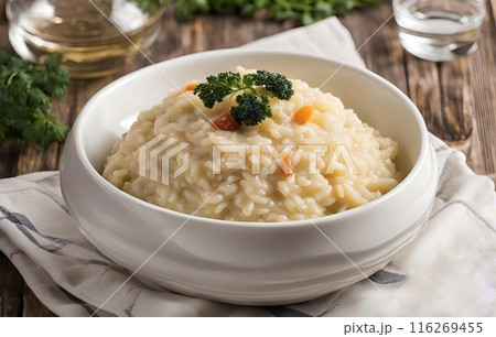 Creamy Parmesan risotto, a rich Italian dish with Arborio rice, butter, Parmesan cheese and herbs, offering a velvety texture and savory flavor. AI Generated 116269455