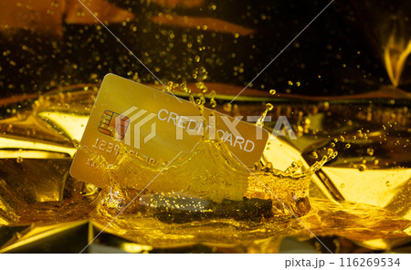 Plastic credit card create in liquid gold with trust. Golden credit card mining from gold and casting into name card shape for credit trust new money, king crown water liquid splash 116269534