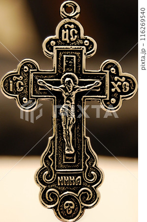 Body-worn cross with crucifix.A pronounced cross with a beautiful background bokeh. 116269540
