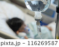 Asian todler in hospital with intravenous saline. Sick children, infected with the virus, are lying and being treated in beds in hospitals. 116269587