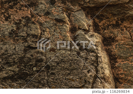 Dark red orange brown stone with cracks Closeup of uneven mountain surface Dark red orange brown stone with cracks Closeup of uneven mountain surface 116269834