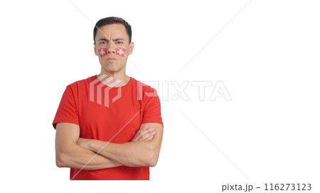 Dignified and serious man with swiss flag painted on face Dignified and serious man with swiss flag painted on face 116273123