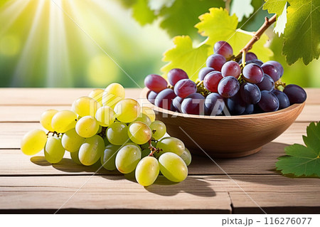 Green grapes on wooden table, green grapes with sunlight, sweet green grapes on wood background. Green grapes on wooden table, green grapes with sunlight, sweet green grapes on wood background. 116276077