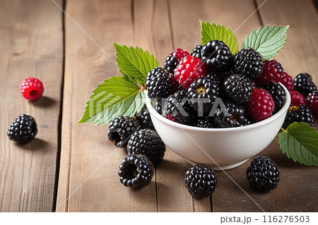 Fresh blackberries on wooden table, blackberries with sunlight, sweet berry on wood background. 116276503