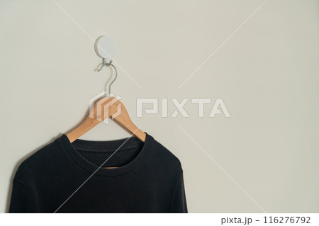black sweater hanging on hanger black sweater hanging on hanger 116276792