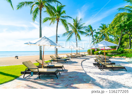 Beautiful umbrella and chair around swimming pool in hotel and resort 116277205