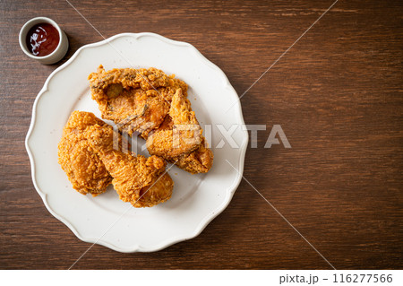 fried chicken with ketchup on plate fried chicken with ketchup on plate 116277566