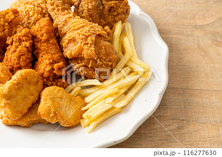 fried chicken with french fries and nuggets on plate fried chicken with french fries and nuggets on plate 116277630