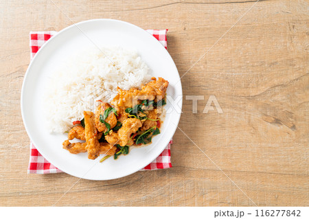 stir-fried fried fish with basil and chili in thai style topped on rice 116277842