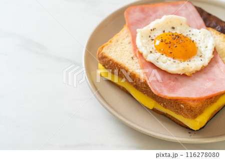 bread toasted cheese topped ham and fried egg with pork sausage 116278080
