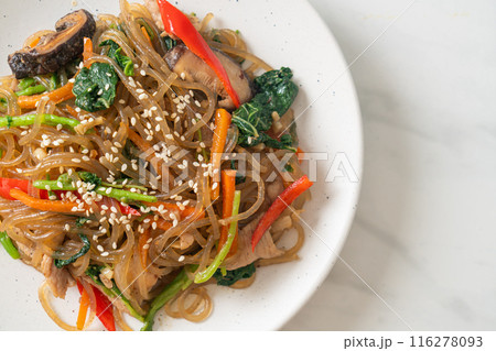 japchae or stir-fried Korean vermicelli noodles with vegetables and pork topped with white sesame 116278093