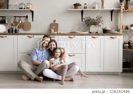 Portrait of happy family sit on floor with little daughter 116281486