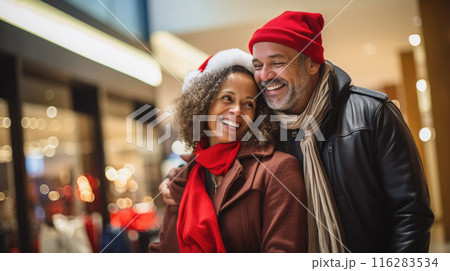 Happy middle aged couple shopping during Christmas season at the shopping mall Happy middle aged couple shopping during Christmas season at the shopping mall 116283534