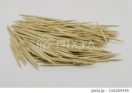 Pile of wooden toothpicks on white background Pile of wooden toothpicks on white background 116284349