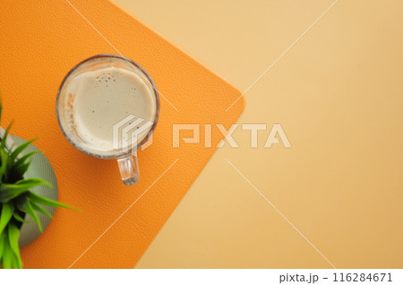 Coffee mug, plant, orange and beige background for cozy and warmtoned home decor Coffee mug, plant, orange and beige background for cozy and warmtoned home decor 116284671