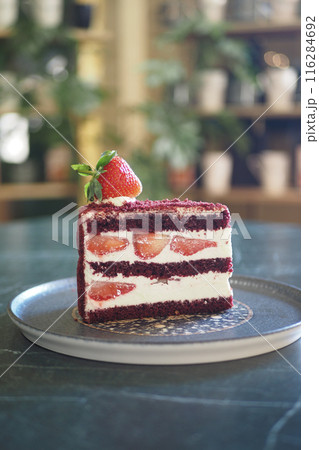 Strawberry chiffon cake on a plate against cafe background Strawberry chiffon cake on a plate against cafe background 116284692