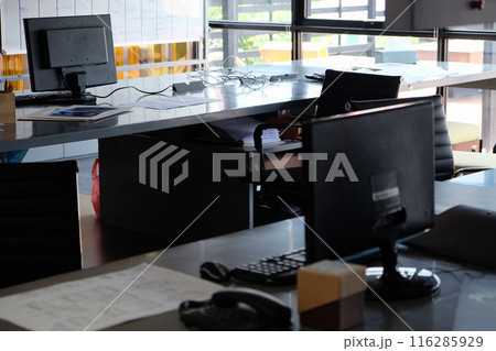 Close up of a desk in a modern office with a computer and telephone 116285929