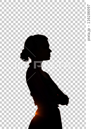 Silhouette of a woman with her arms crossed looking up at the sky 116286097
