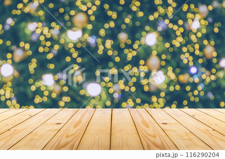 Empty wood table top with blur Christmas tree with bokeh light background Empty wood table top with blur Christmas tree with bokeh light background 116290204