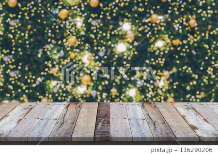 Empty wood table top with blur Christmas tree with bokeh light background Empty wood table top with blur Christmas tree with bokeh light background 116290206